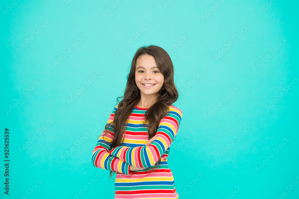 Obraz premium Happy child. Happy childrens day. Childhood concept. Little girl turquoise background. Shopping day. Items for small girl. Nice time to be child. Kid fashion. Smiling school girl. Kid long hair