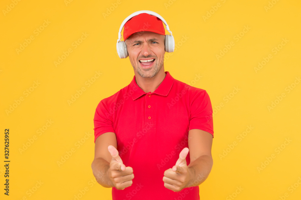 Let music speak. Happy man give thumbs ups yellow background. Enjoying favorite music. Handsome guy wear headphones playing music. Listening to music and singing along to song