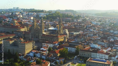 Aerial, pan, drone shot overlooking the Cathedral of Santiago de Compostela and the cityscape, golden hour, in Saint James of Compostella, Galicia, Spain