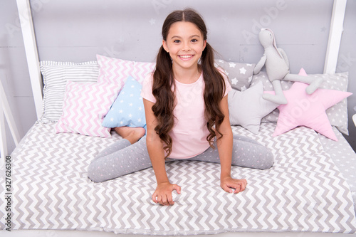 Pediatric care. Happy kid sit on bed. Little baby with healthy smile. Childhood care. Child care and health. Healthcare. Childcare. Day care and child development