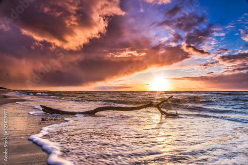 Fototapeta Naklejka Na Ścianę i Meble -  Beautiful cloud cover over the sea sunset at the beach - dramatic sunset on the baltic sea