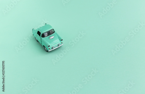 Toy Car on the road  on a mint green background . 