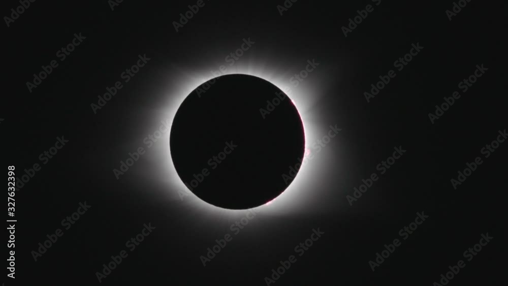 Telephoto tracking shot of total solar eclipse as it begins to flare.