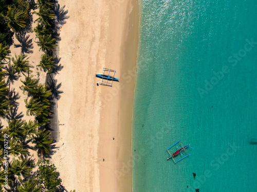 Aerial drone top down of pagudpud beach phillipines with fisherboats photo