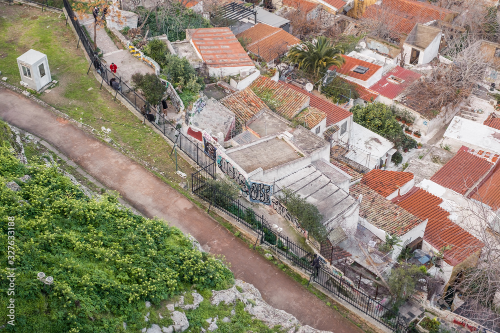 Fototapeta premium Aerial view of preserved historic buildings in the Plaka neighborhood of Athens, on the slopes of Acropolis, Greece