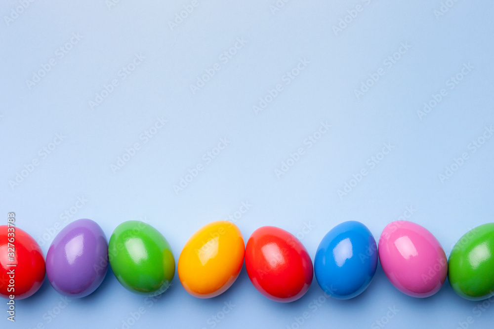 Flat lay composition with Easter eggs on color background. Frame made of decorated eggs. Top view with place for text Flat lay composition with Easter eggs on color background. Frame made of decorated eggs. Top view with place for text