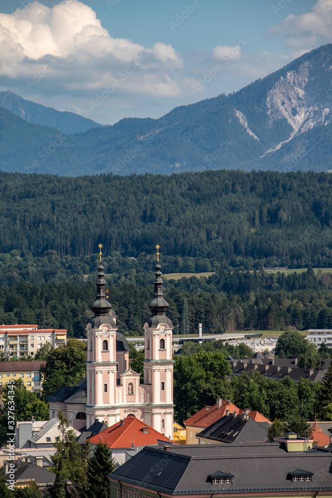 Panorama of the city of Villach with historical churches and a castle in front of the mountains of the Karawanken Mountains in the Austrian Alps,Europe