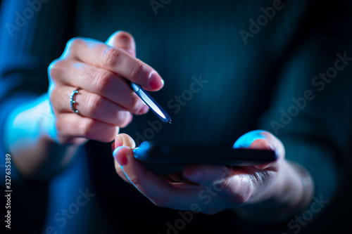 Woman holds a phone and a s...
