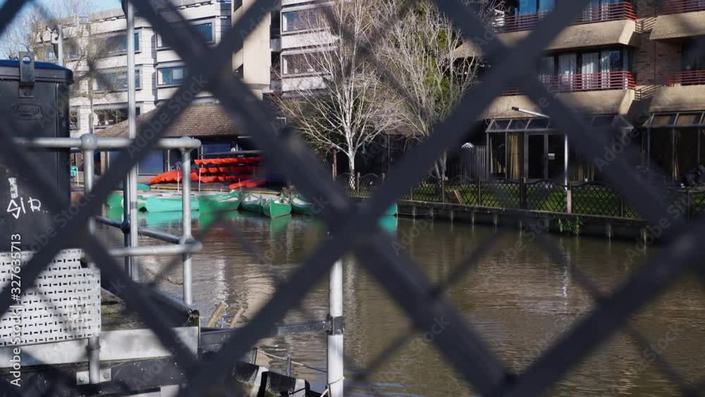 Artistically Shot made behind a wood fence, of the River Cam, river that gives name to the city of Cambridge , England. Artistically Shot made behind a wood fence, of the River Cam, river that gives name to the city of Cambridge , England.