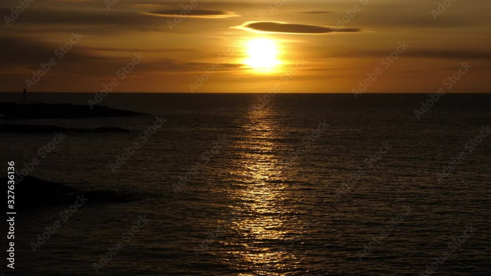 Static shot of sunrise above the Skagerrak sea, on Justoya island, on a sunny morning, in Aust-Agder, Norway Static shot of sunrise above the Skagerrak sea, on Justoya island, on a sunny morning, in Aust-Agder, Norway
