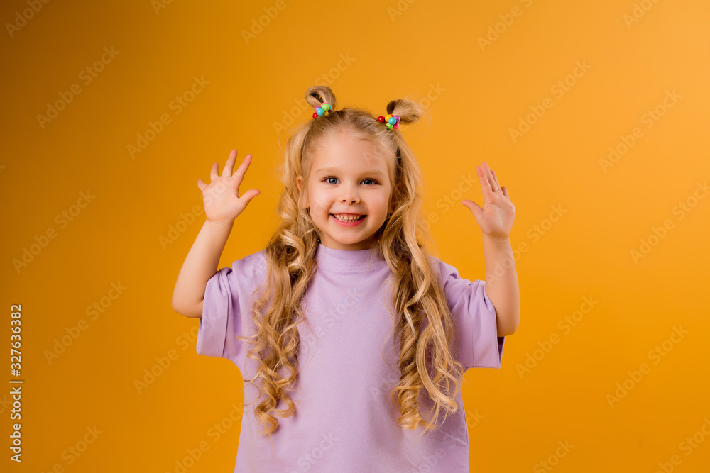portrait of a happy child girl isolate on a yellow background, space for text portrait of a happy child girl isolate on a yellow background, space for text