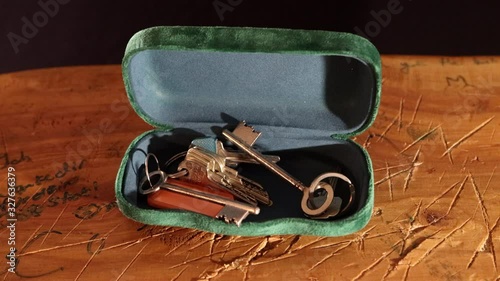 Keybox with antique keys on scratched vintage wood table puting key photo