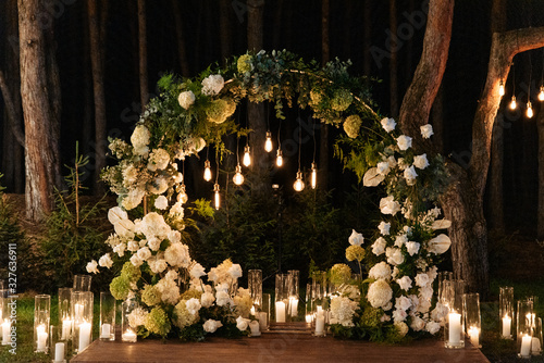 Evening wedding ceremony with garlands of lamps
