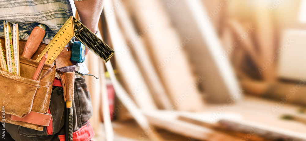 The carpenter with measuring and work tools in leather belt. Wide banner or panorama concept. - obrazy, fototapety, plakaty 