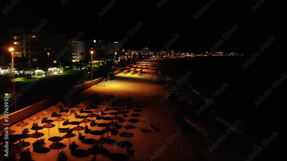 Drone flight over an empty beach in Mallorca, Spain at nighttime.