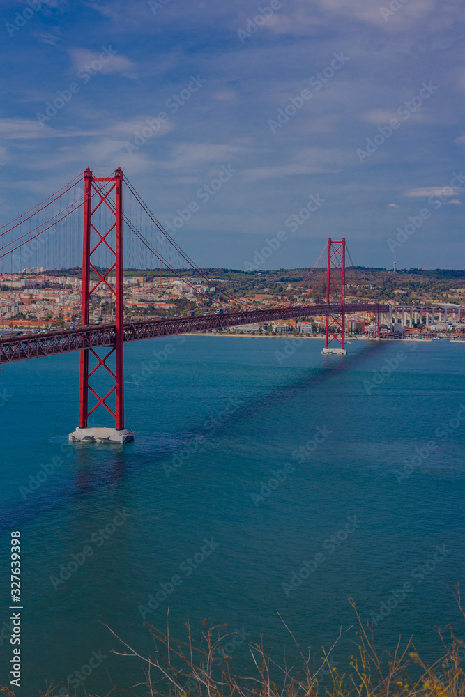 Fototapeta premium Ponte 25 de Abril is a suspension bridge connecting the city of Lisbon, to the Almada