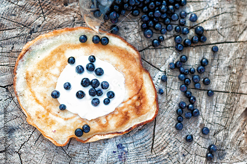 Blueberry and berry pancake with sour cream photo