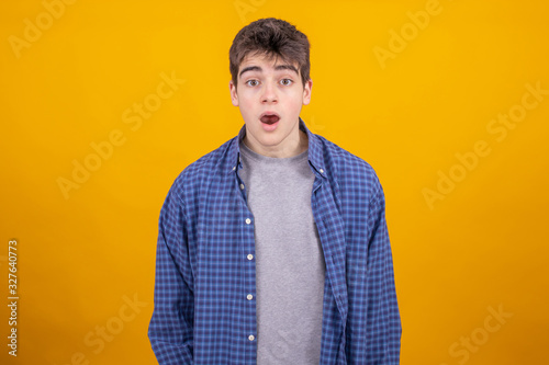 portrait of young casual man or student isolated on color background