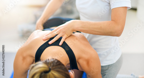 Fototapeta Naklejka Na Ścianę i Meble -  Physiotherapist working with athlete patient in clinic centre, therapy hands detail.