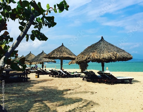 tropical beach with chairs and umbrellas © андрей т
