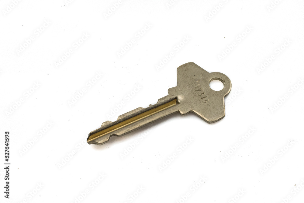 A brass dooknob key, close up, isolated on a clean, white background. Shot in macro. A brass dooknob key, close up, isolated on a clean, white background. Shot in macro.