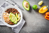 Healthy dish plate with quinoa, chicken, avocado, lime on concrete background top view. Food and health. Superfood meal