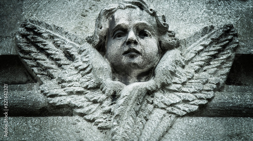 Fotografia, Obraz Close up of angel with wings. Ancient stone statue.