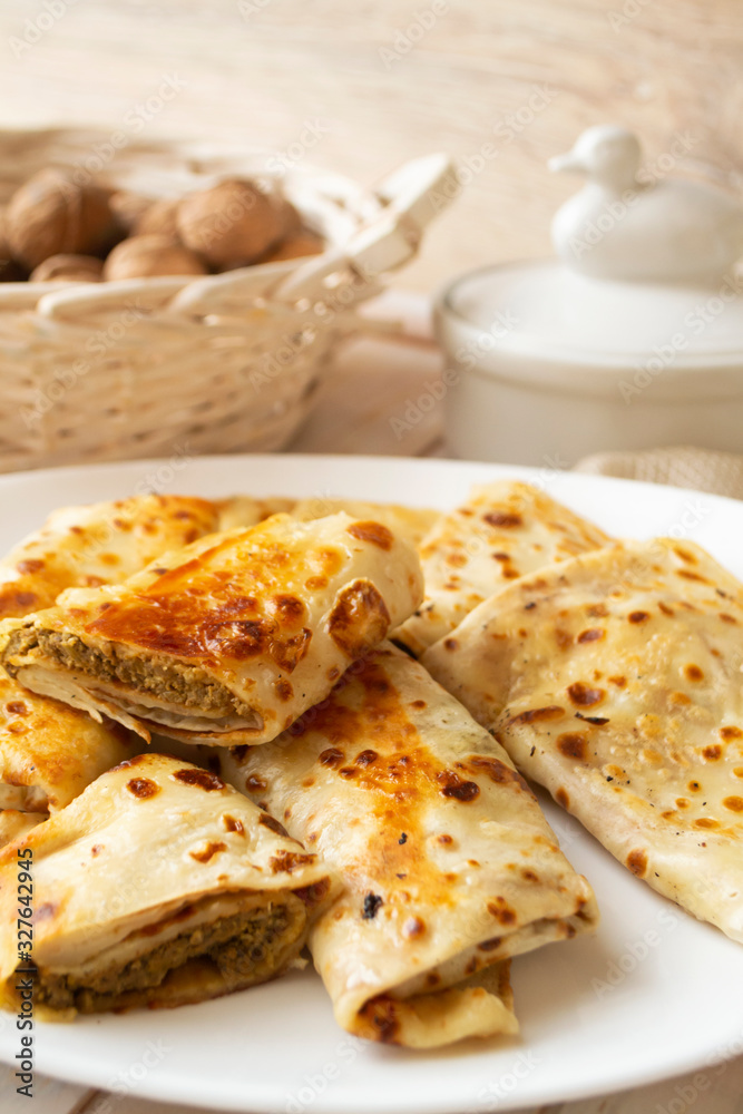 tasty stuffed pancakes crepes with meat close up. Thin pancakes with fillings. Russian fried stuffed pancakes blintzes with meat and giblets, heart, lung, liver.