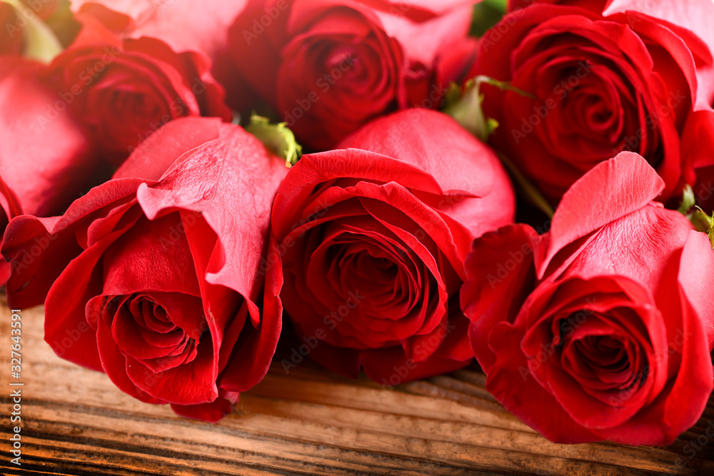 Red roses on old rustic table. Valentines day rose flowers. Red roses on old rustic table. Valentines day rose flowers.