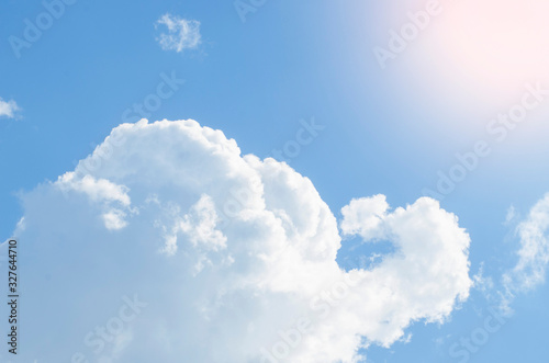 Cumulus clouds against a clear blue sky. Copy space for inscriptions about travel, reflection, weather and the summer season.