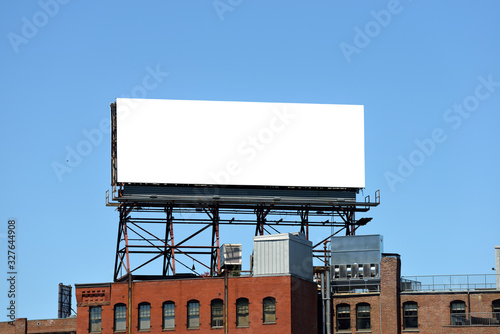 Large Billboard On Roof Top Of Brick Building photo