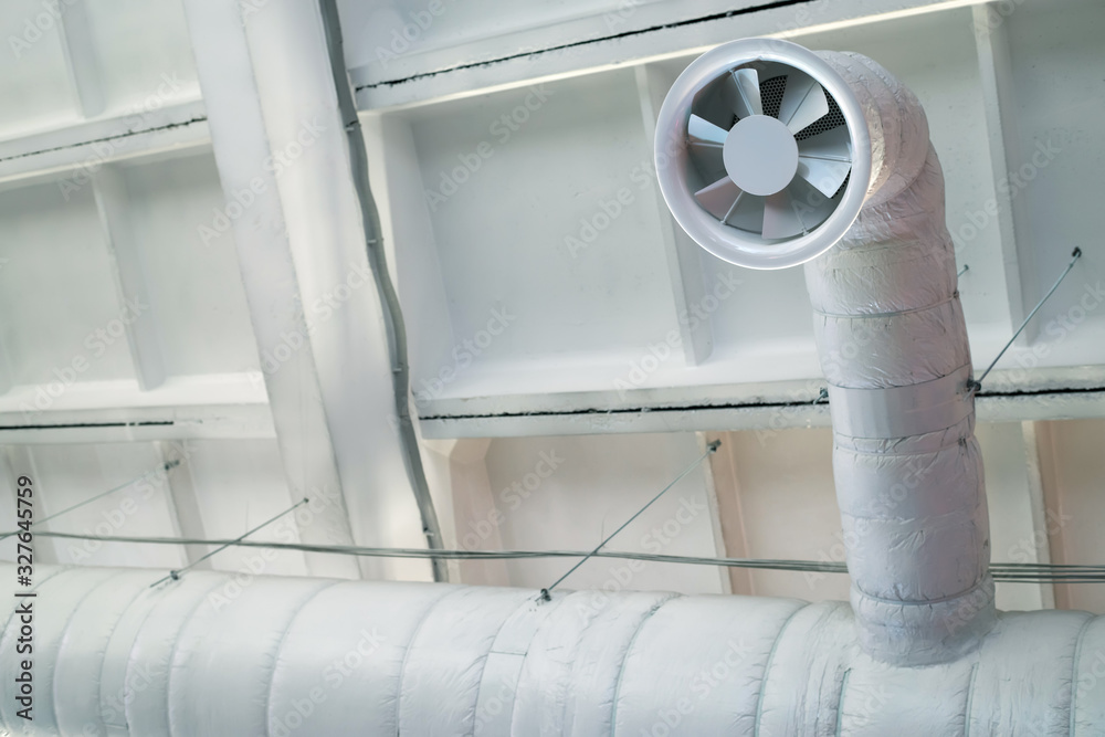 Exhaust fan of the ventilation system on the concrete ceiling of an