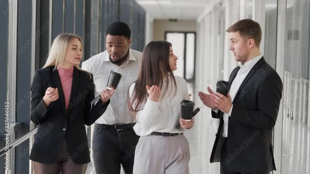 young business people are walking and drinking the corridors of the business center young business people are walking and drinking the corridors of the business center
