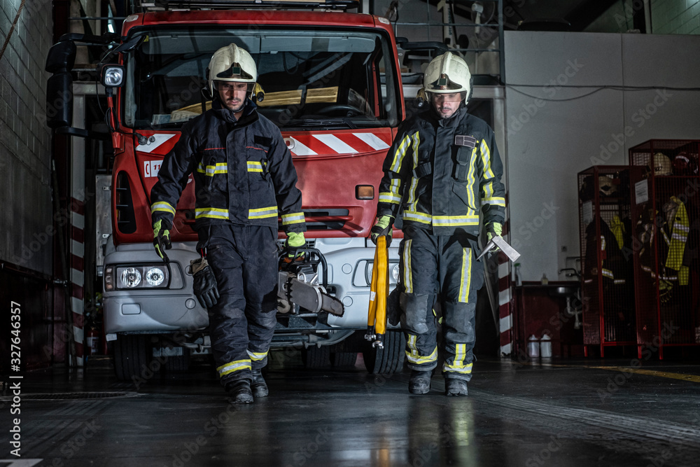 firemen leaving the station equipped and with the tools for the extinction of the fire firemen leaving the station equipped and with the tools for the extinction of the fire