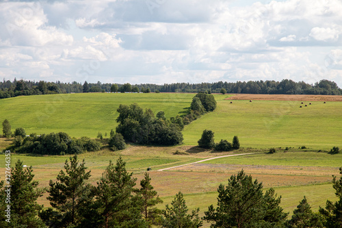 Hilly landscape at sunny day with blue sky and clouds