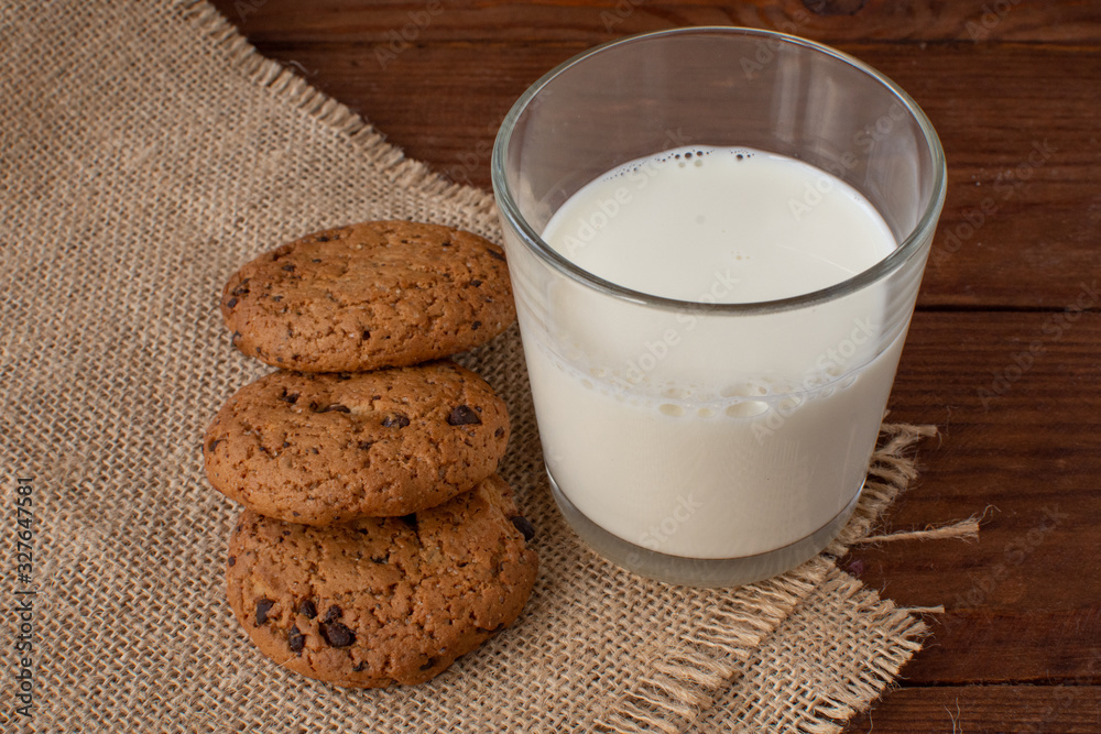 Homemade cow's milk with cookies on a wooden background. Rustic style. Still-life. Homemade cow's milk with cookies on a wooden background. Rustic style. Still-life.