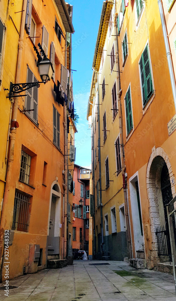 view of houses on a narrow street in the Italian style in Nice, France