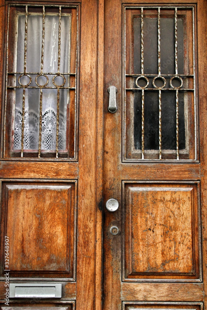Old wooden door with wrought iron details Old wooden door with wrought iron details