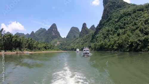 Two sightseeing boats carrying tourists on a journey on the magnificent Li river from Guilin to Yangshuo, China photo