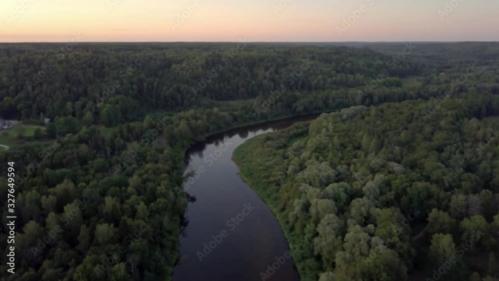 Gauja River during sunset. Aerial dolly in, pan down Gauja River during sunset. Aerial dolly in, pan down