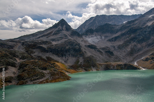 View of the Alpine glacier swaying into the mountain turquoise lake
