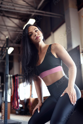 Beauty portrait of fitness woman, wearing black sportswear. Gym lifestyle.