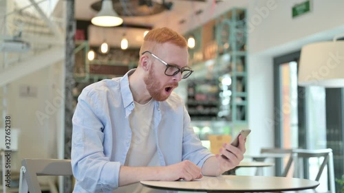 Wallpaper Mural Redhead Man Reacting to Loss on Phone in Cafe  Torontodigital.ca