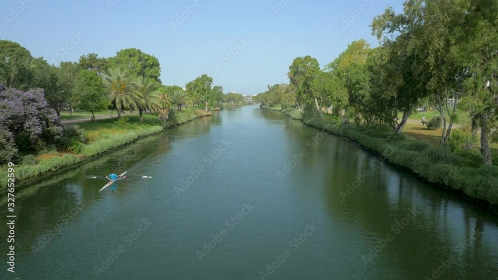 Kayak athlete practicing in the yarkon river. Aerial footage, dolly forwards. Kayak athlete practicing in the yarkon river. Aerial footage, dolly forwards.