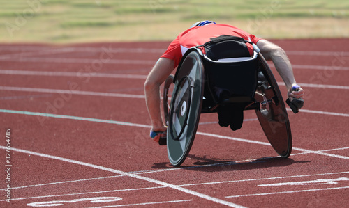 athlete runs on the wheelchair in the running track