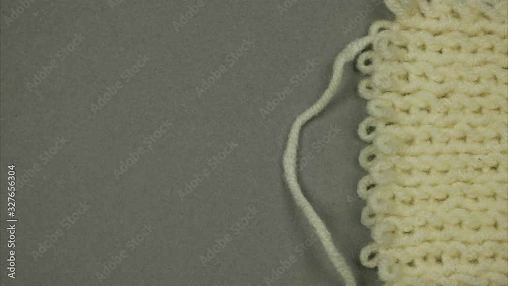 Knitted surface. Thread knits loops forming a background. Stop motion