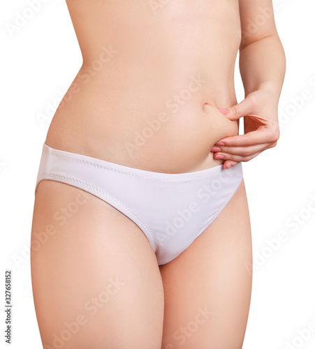 Unrecognizable woman pinch belly fat. © Galaxy_love_design