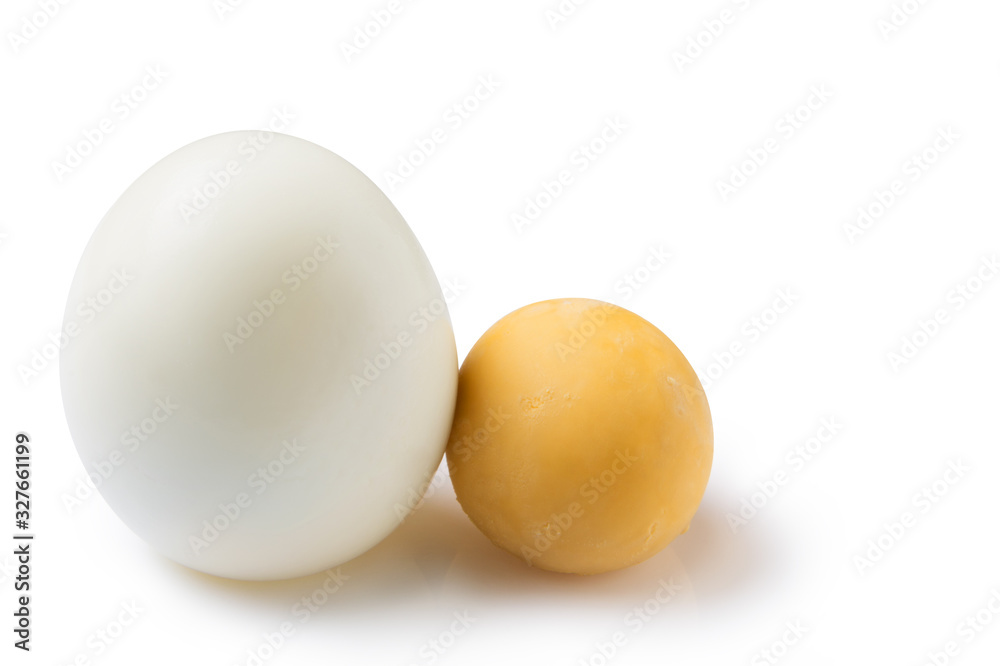 peeled boiled egg, on a white background, lies next to a round yolk, food concept peeled boiled egg, on a white background, lies next to a round yolk, food concept