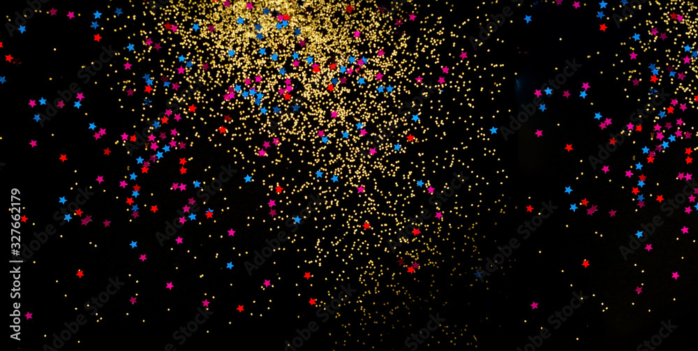 Black background with golden sparkles. Blurred effect. Concept for festive background