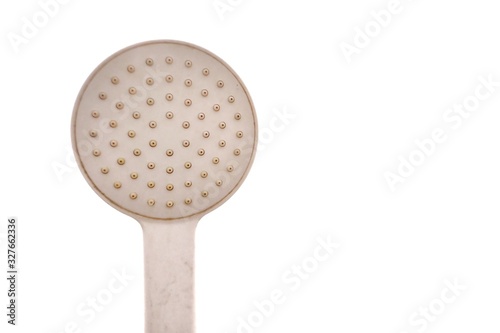 An old dirty shower head in a restroom on white isolated background with copy space
